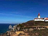 Thumbnail photo of a lighthouse on a promontory linking to Cabo da Roca photo page